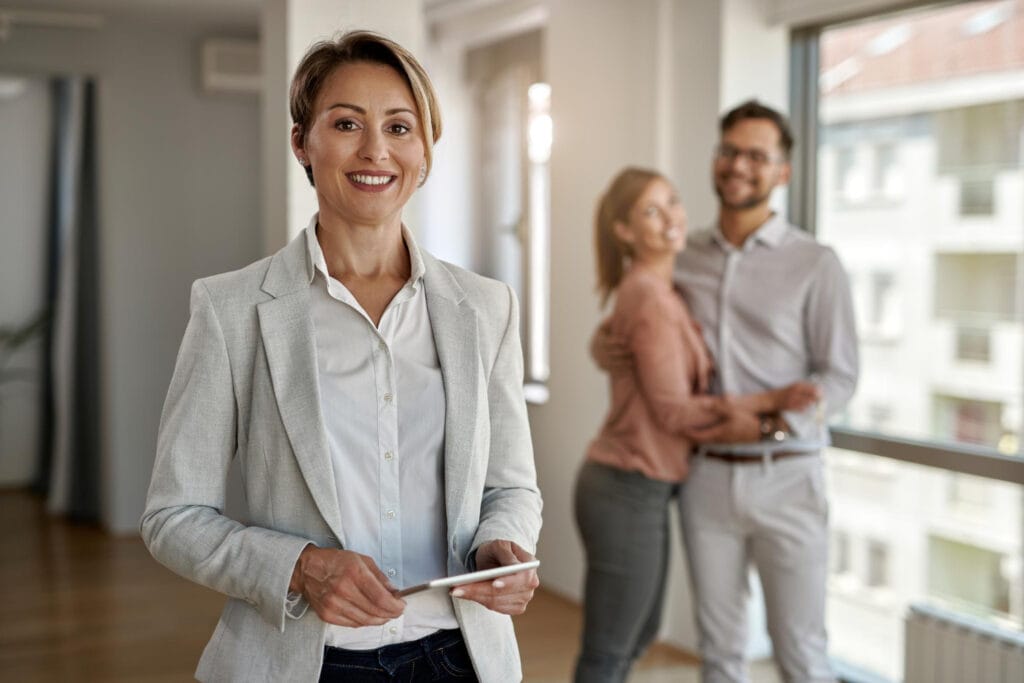 Eine Immobilienmaklerin hat gerade ein Haus an ein glückliches Pärchen verkauft.